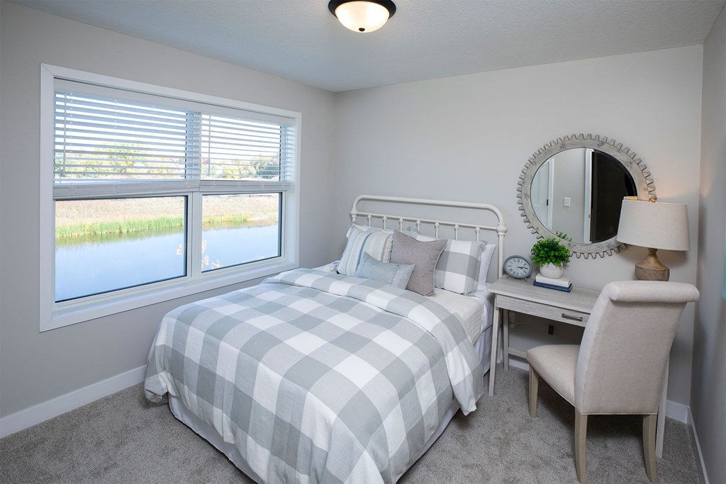 a bedroom with a bed and a desk