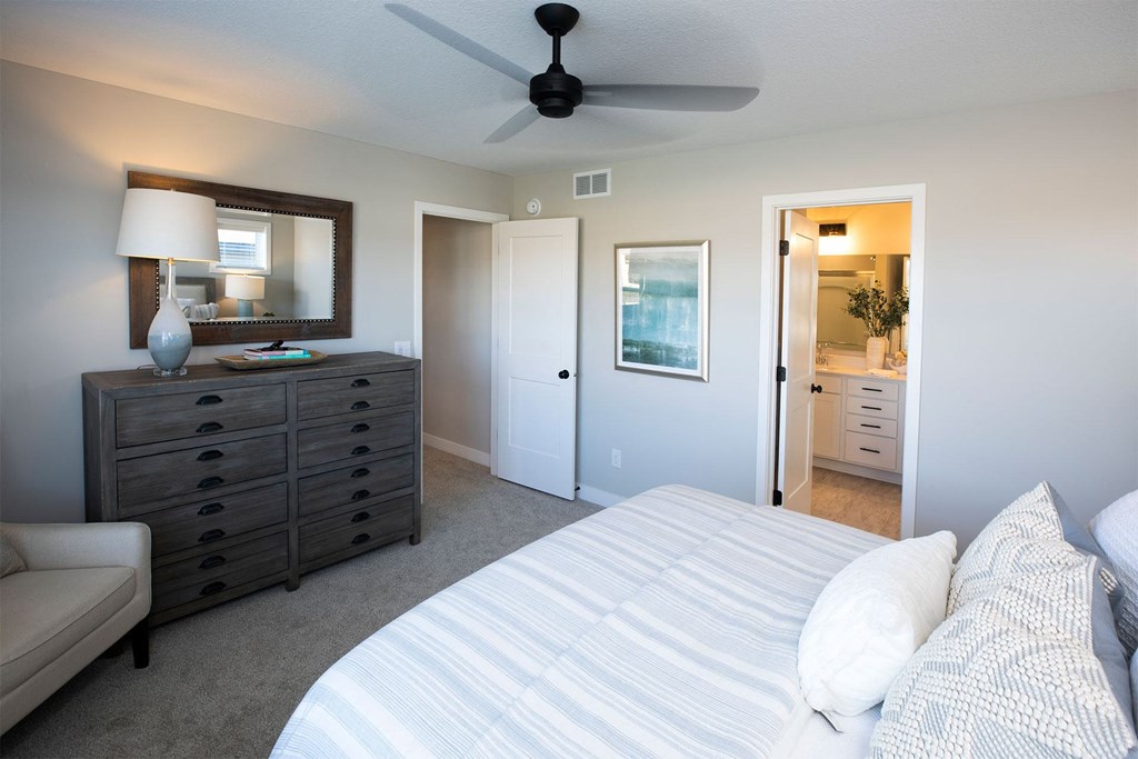 a bedroom with a bed and a dresser