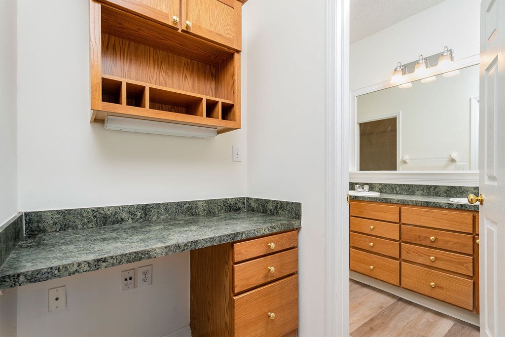 a kitchen with granite counter tops and wooden cabinets