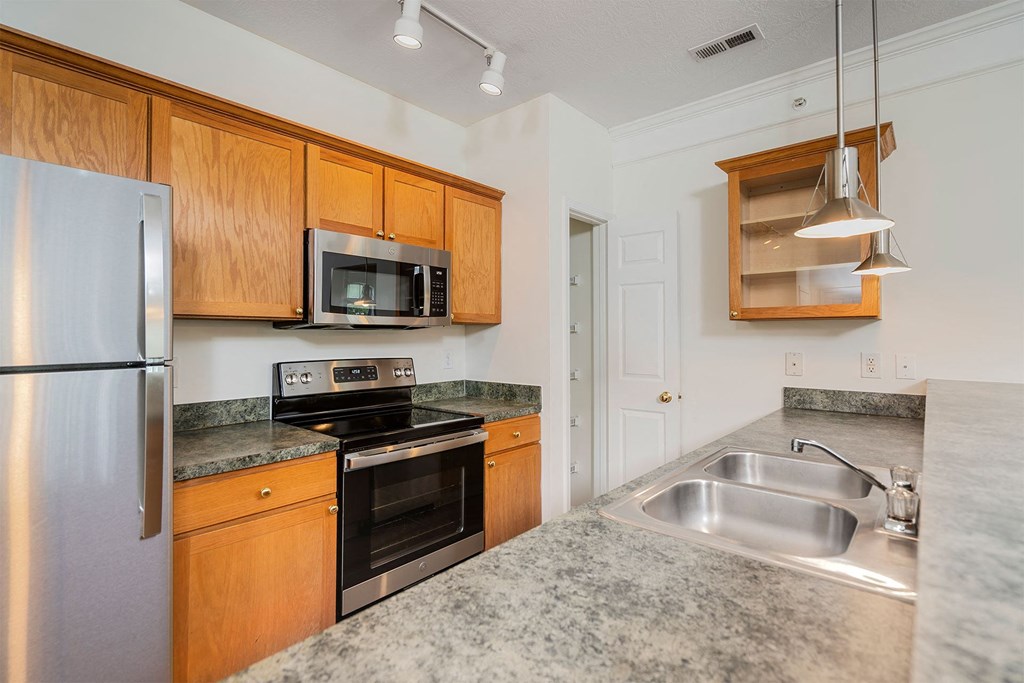 a kitchen with stainless steel appliances and granite counter tops