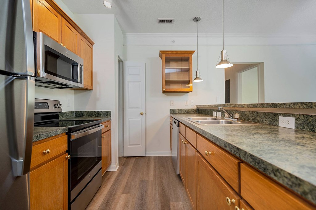 a kitchen with granite counter tops and stainless steel appliances