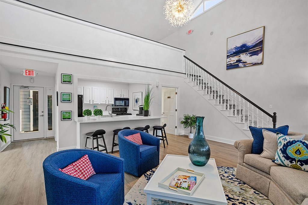 A living room with a blue chair and a coffee table.