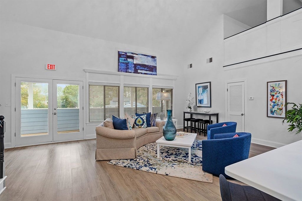 A living room with a couch, chairs, and a coffee table.