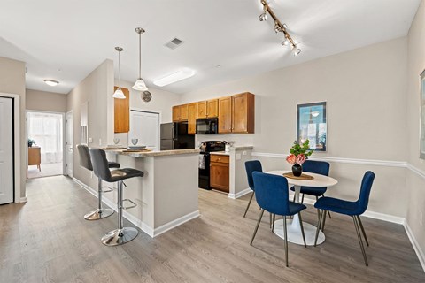 a kitchen and dining area with a table and chairs