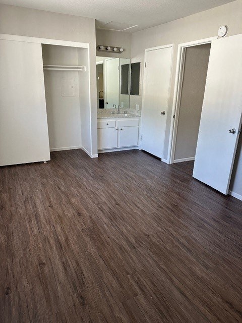 an empty room with a sink and a mirror