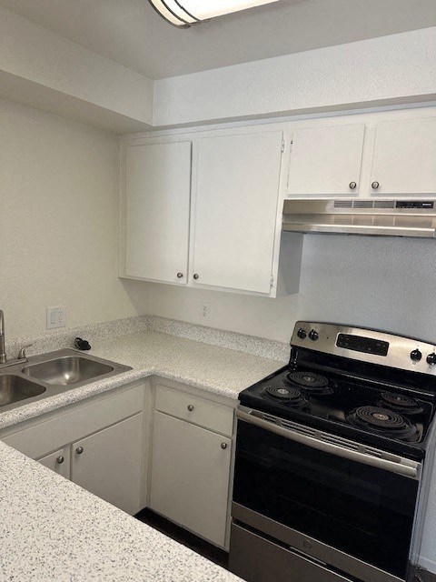 a kitchen with a stove and a sink