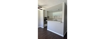 A kitchen with white cabinets and a countertop.