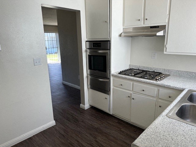an empty kitchen with a stove and a sink