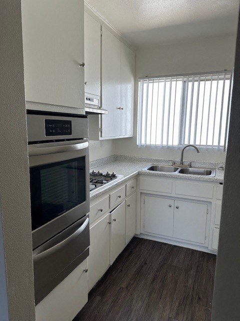 a kitchen with a stainless steel oven and a sink