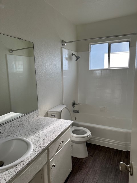 an empty bathroom with a toilet and a sink