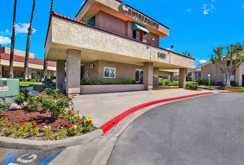 Covered porte cochere entrance with address number at CENTREPOINTE Apartments, Colton, California
