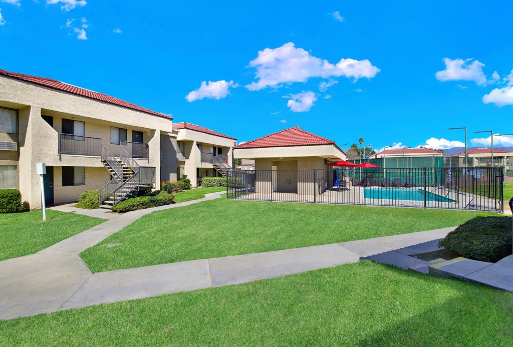 A sunny day at the apartment complex with a clear blue sky.