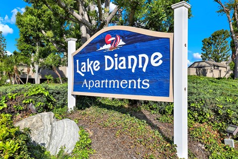 A sign for Lake Dianne Apartments is displayed in front of a landscaped area.