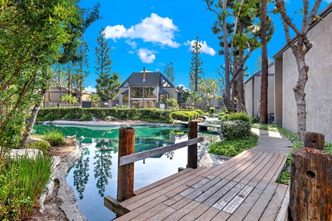 Wooden dock overlooking serene community pond at LAKE DIANNE Apartments, Santa Ana, CA 92705