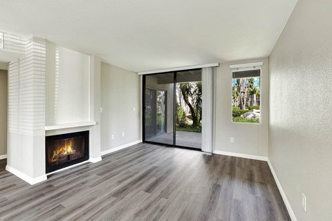 A modern living room with a fireplace and sliding glass doors.