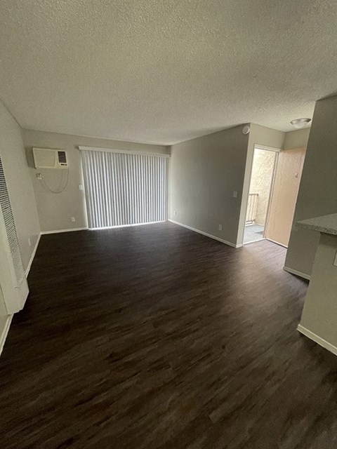 an empty living room with a wood floor