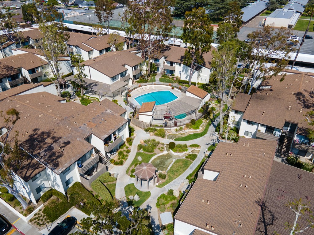 an aerial view of a house with a swimming pool in the middle