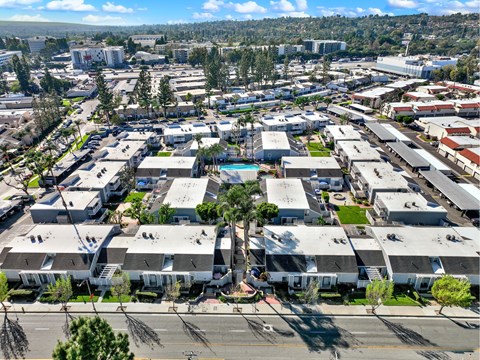 A large industrial area with multiple buildings and a swimming pool in the center.