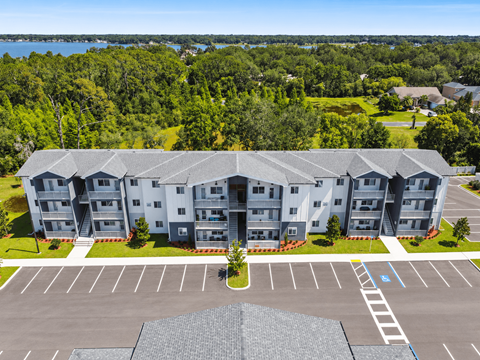 an aerial view of an apartment building and parking lot at Gibson Oaks, Lakeland, 33809.