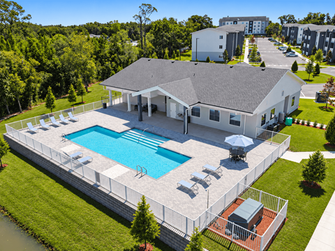 an aerial view of a house with a swimming pool and patio furniture at Gibson Oaks, Lakeland, 33809