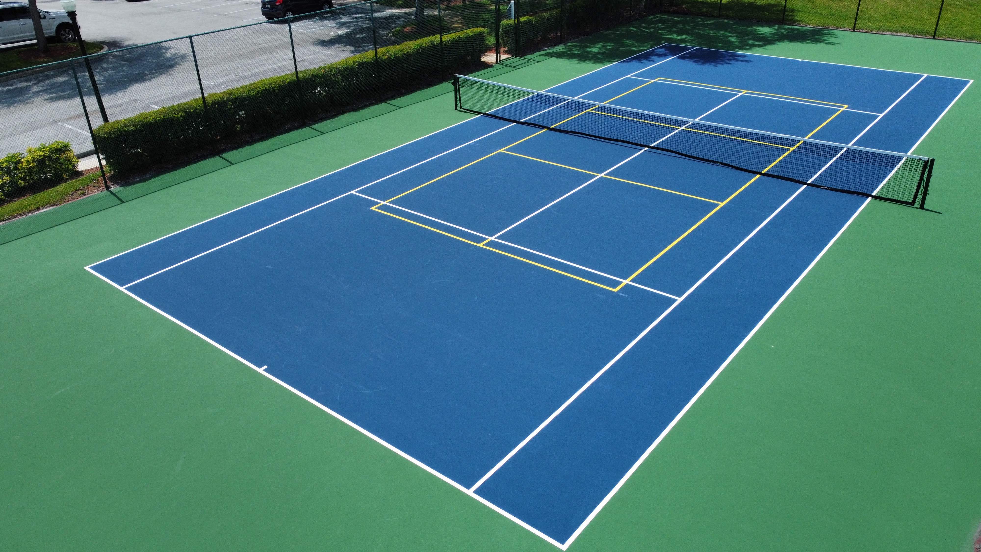 a blue and green tennis court with yellow lines