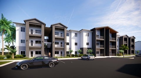 a rendering of an apartment complex with cars parked in front of it at Gibson Oaks, Lakeland, FL, 33809