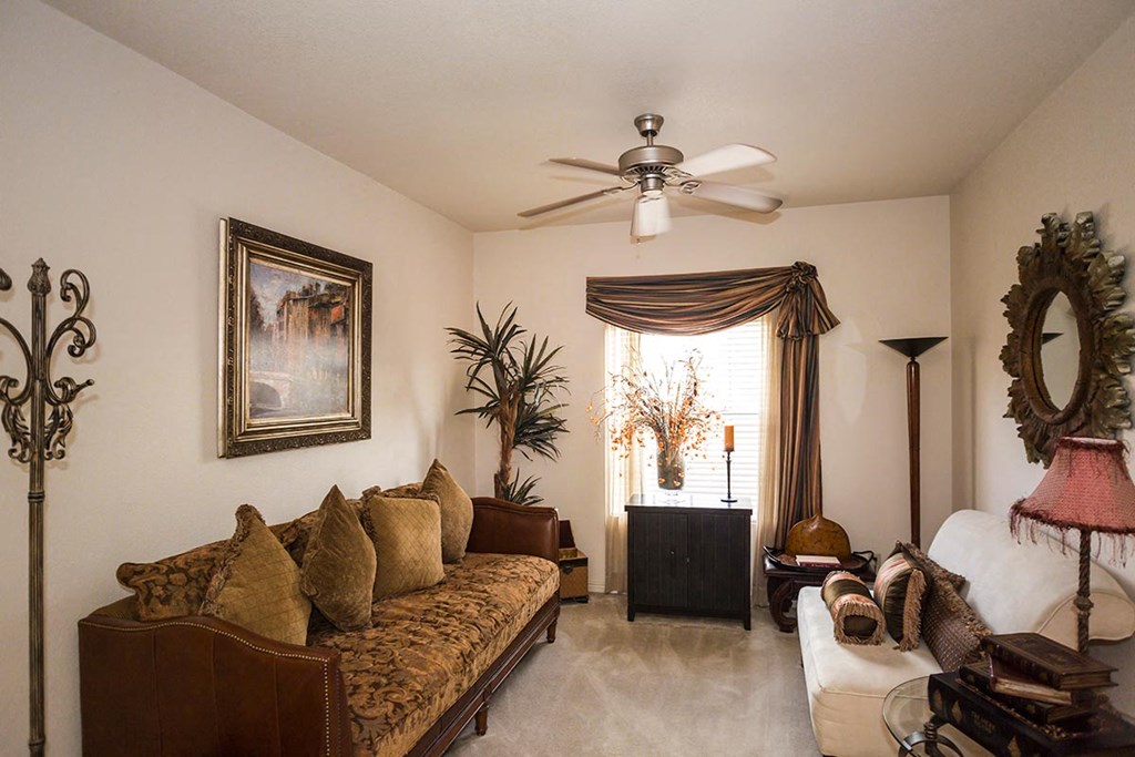 Spacious living with two couches and a ceiling fan