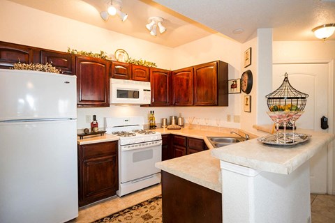a kitchen with white appliances and wooden cabinets