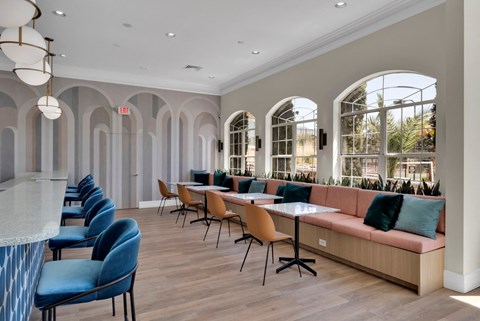 Clubhouse with a long couch and tables and chairs