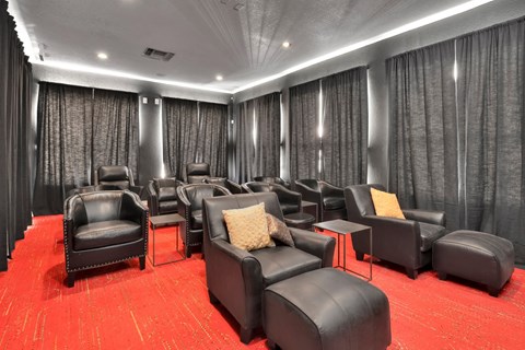 a large screening room with leather chairs and curtains