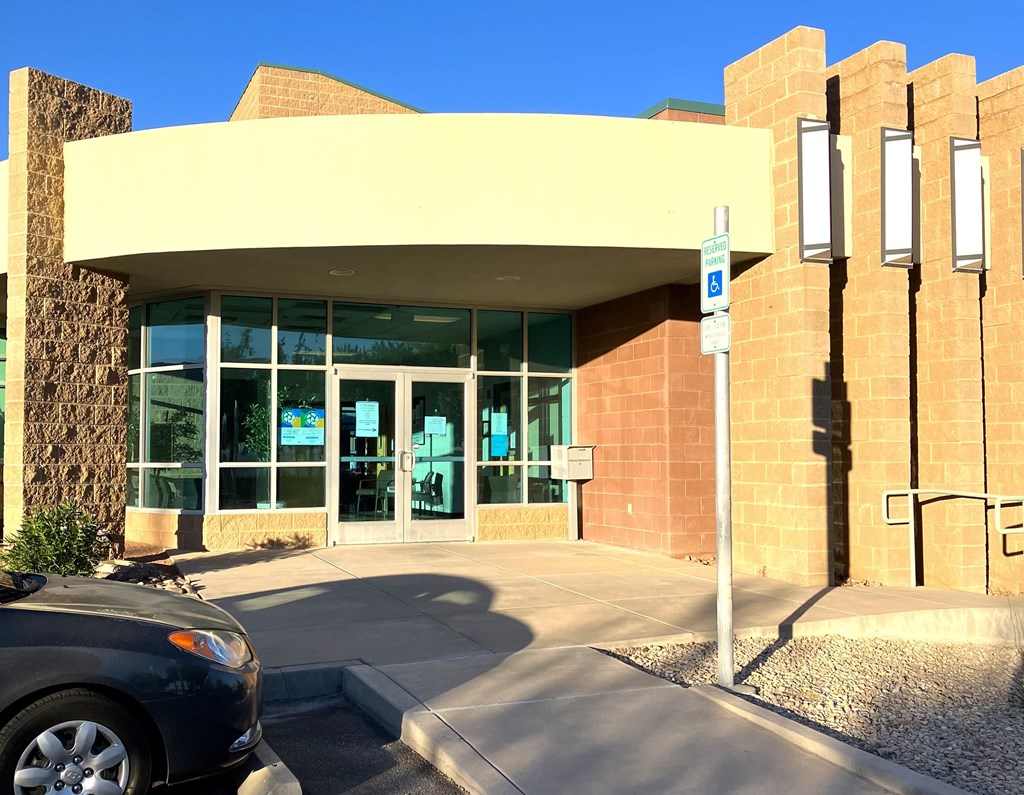 A building with a car parked in front of it.