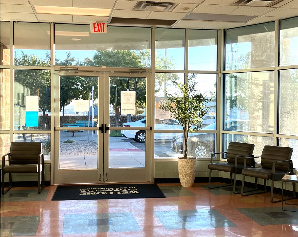 A glass door with an exit sign above it.
