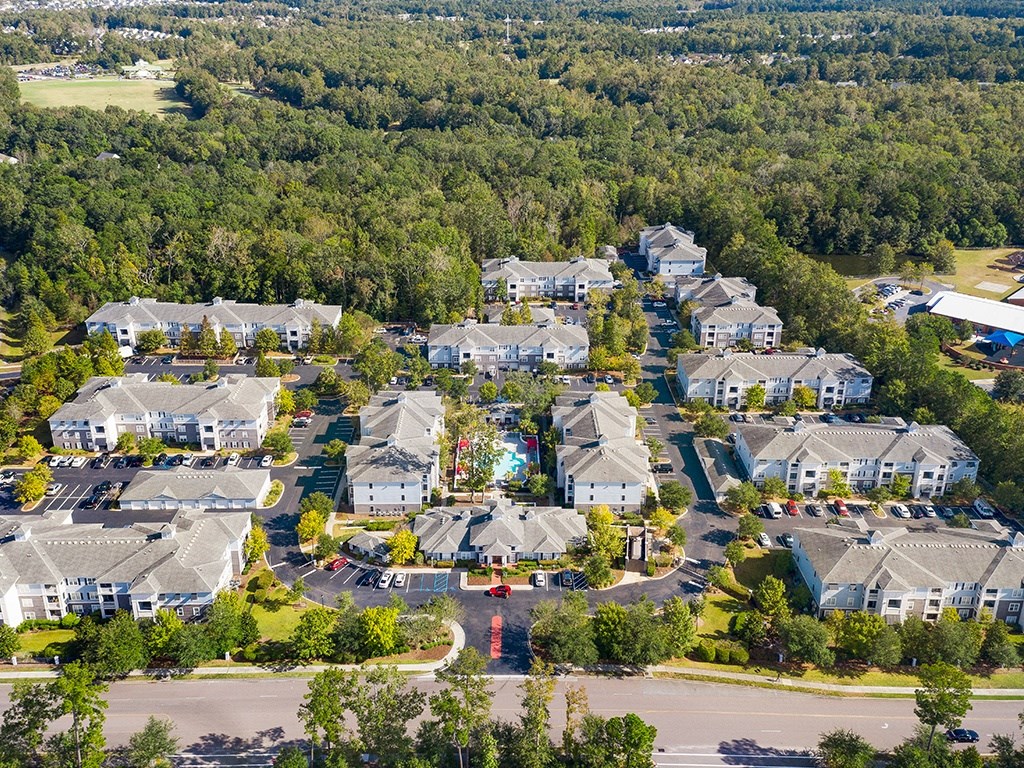 A bird's eye view of a residential area with houses and trees.