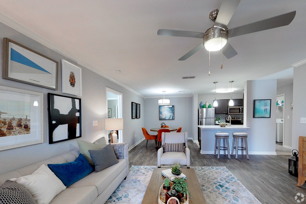 A living room with a grey couch and a coffee table.