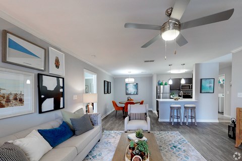 A living room with a grey couch and a coffee table.