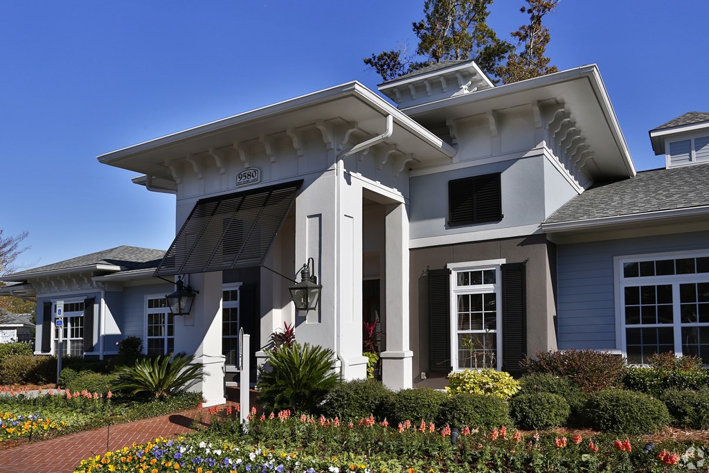 A white house with a blue door and windows.