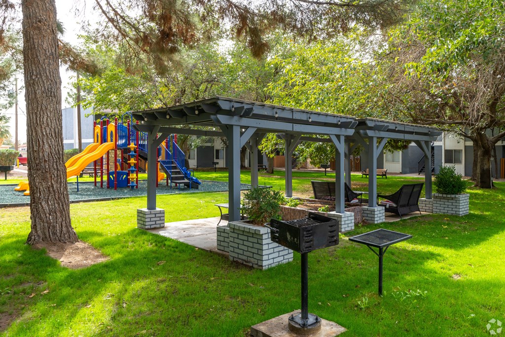 A playground with a slide and a gazebo.