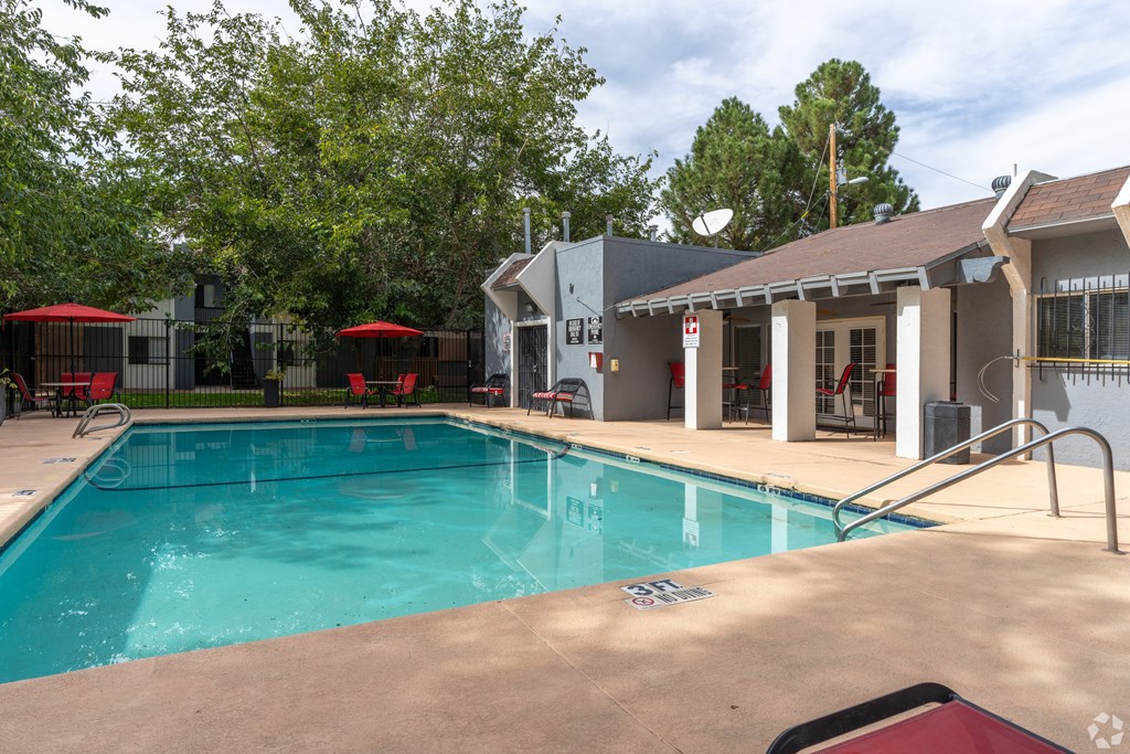 A swimming pool with a building in the background.