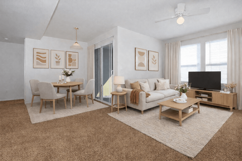 A living room with a sofa, chairs, and a coffee table.