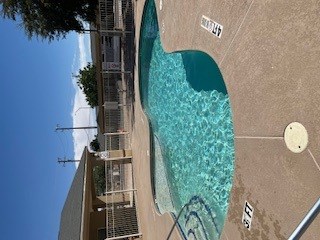 A swimming pool with a yellow ball in the middle of it.