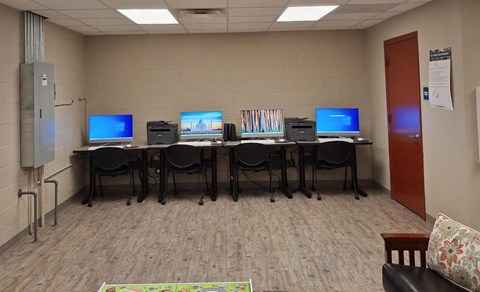 A room with computers and chairs.