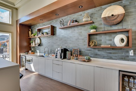 A kitchen with white cabinets and a wooden ceiling.