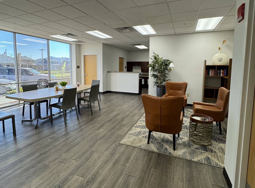 A conference room with a long table and chairs.