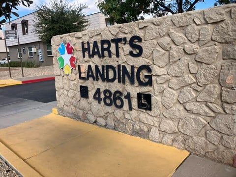 A stone wall with a sign that says Hart's Landing 4861.