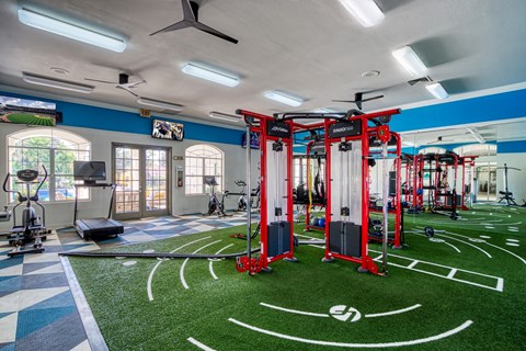 a gym with weights and equipment on a fake football field