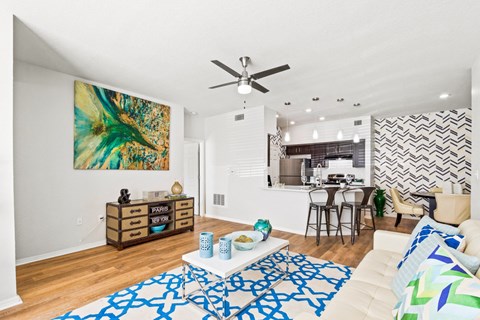a living room with a couch and a ceiling fan