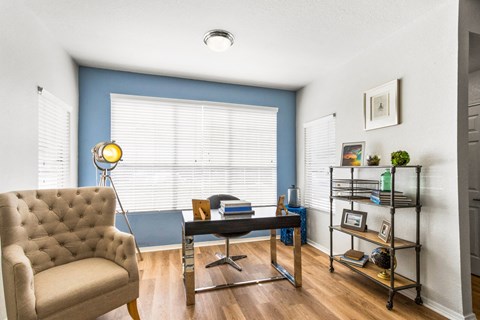 a living room with a large window and a couch and a table