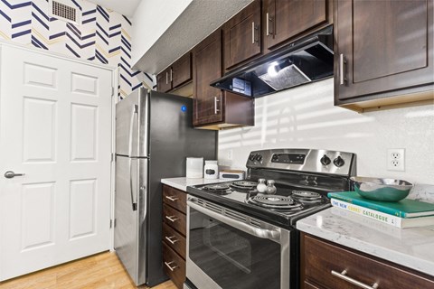 a kitchen with stainless steel appliances and a refrigerator