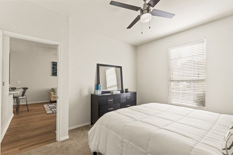 a bedroom with a large bed and a ceiling fan