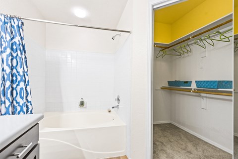 a bathroom with a tub and a shower and a sink